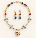Faceted red, yellow, and blue beaded necklace with four angel-wing charms and an enamel rainbow heart pendant, with matching drop earrings