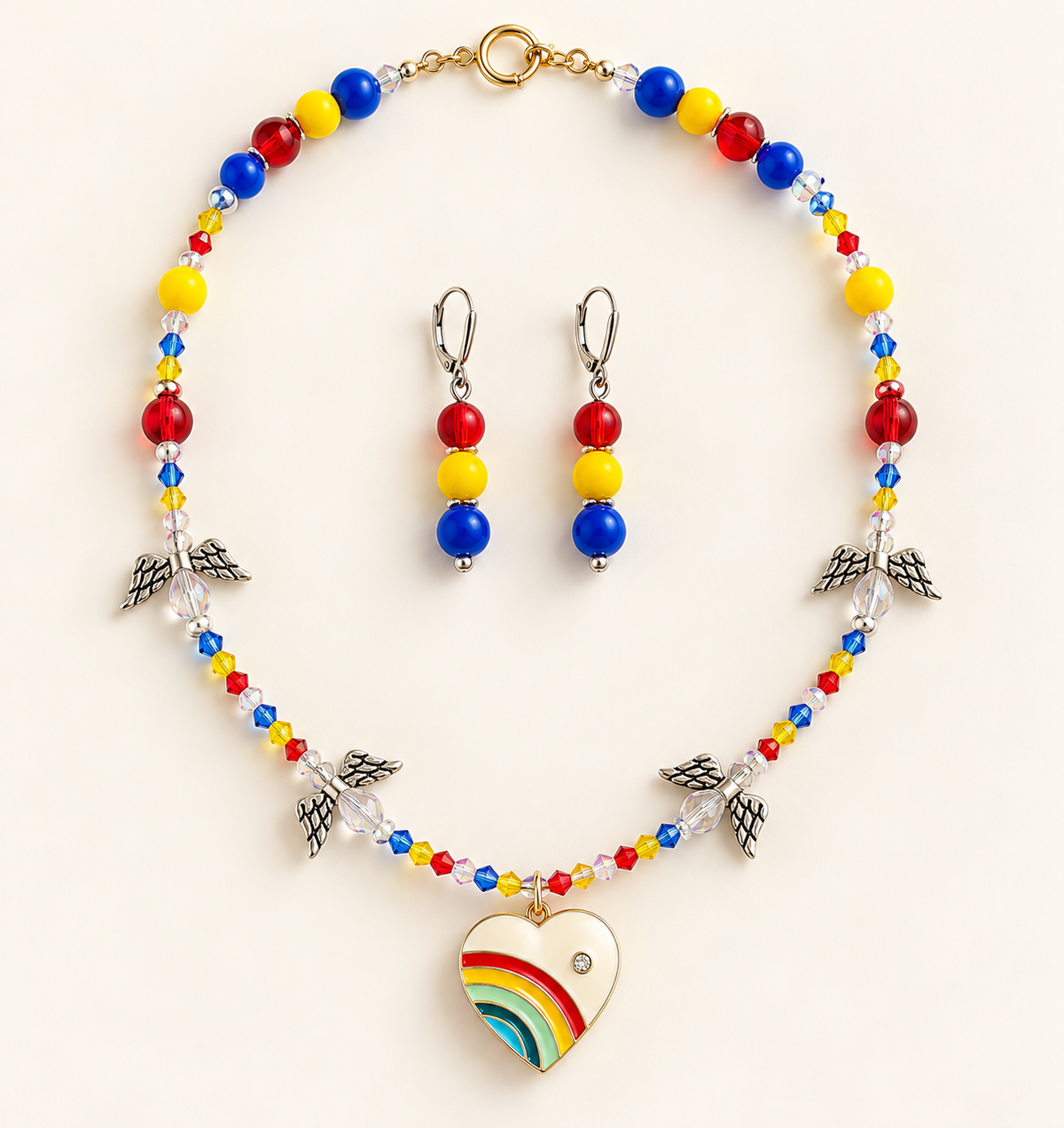 Faceted red, yellow, and blue beaded necklace with four angel-wing charms and an enamel rainbow heart pendant, with matching drop earrings
