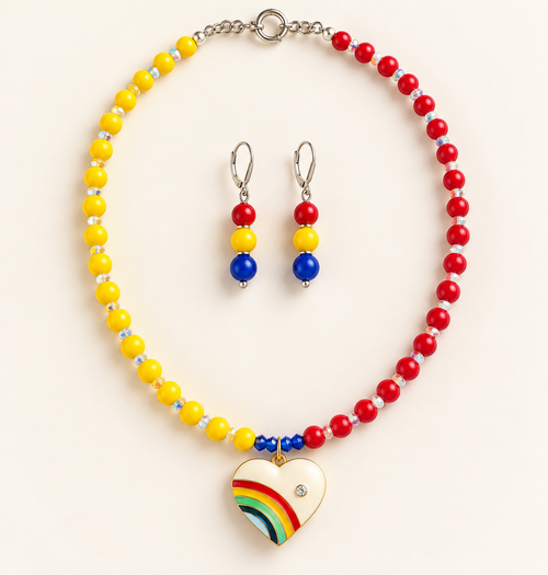 Yellow and red color-block beaded necklace with iridescent spacers, silver-tone clasp, and enamel rainbow heart pendant, with matching silver-tone drop earrings